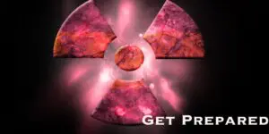 A pink and marbled radioactive symbol glows against a dark background, with “Get Prepared” in white text at the lower right—an urgent reminder about nuclear preparedness.