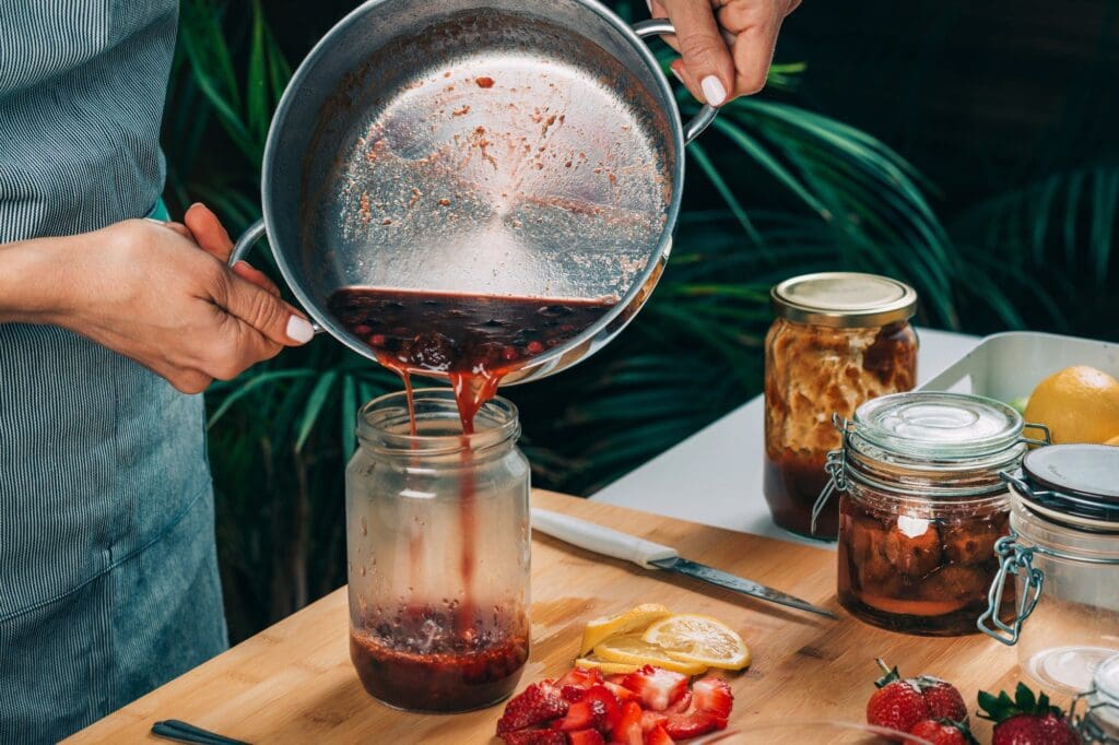 Pouring Fruit Jam into a Jar, Canning at Home.