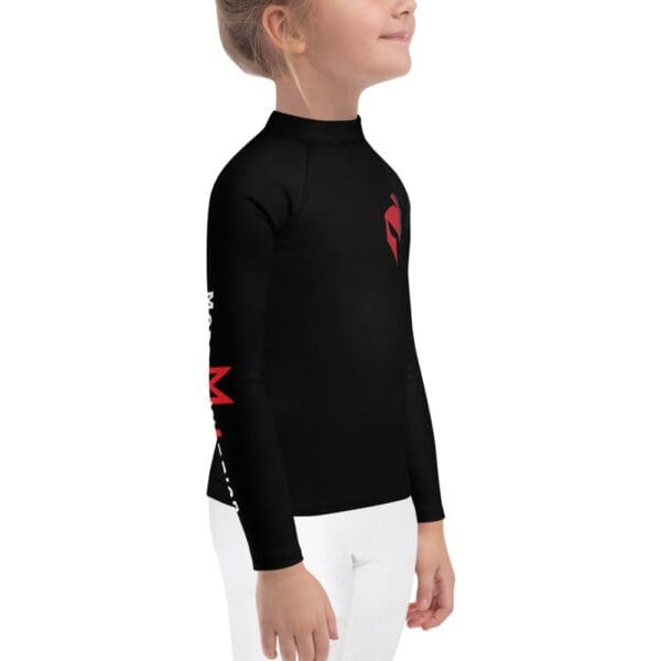 A little girl wearing a MW Combatives Kids Rash Guard.