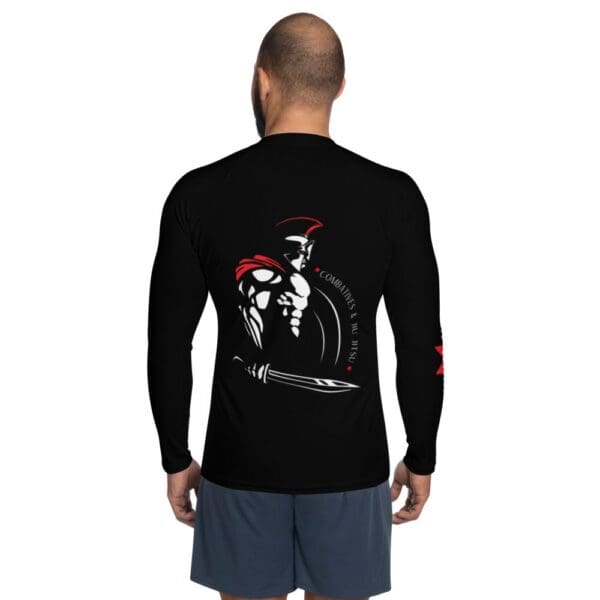 A man wearing a black MW Combatives Men's Rash Guard.