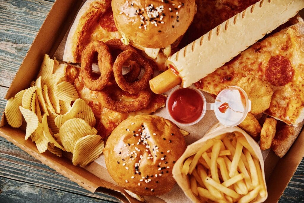 Unhealthy and junk food. Different types of fast food on the table, closeup