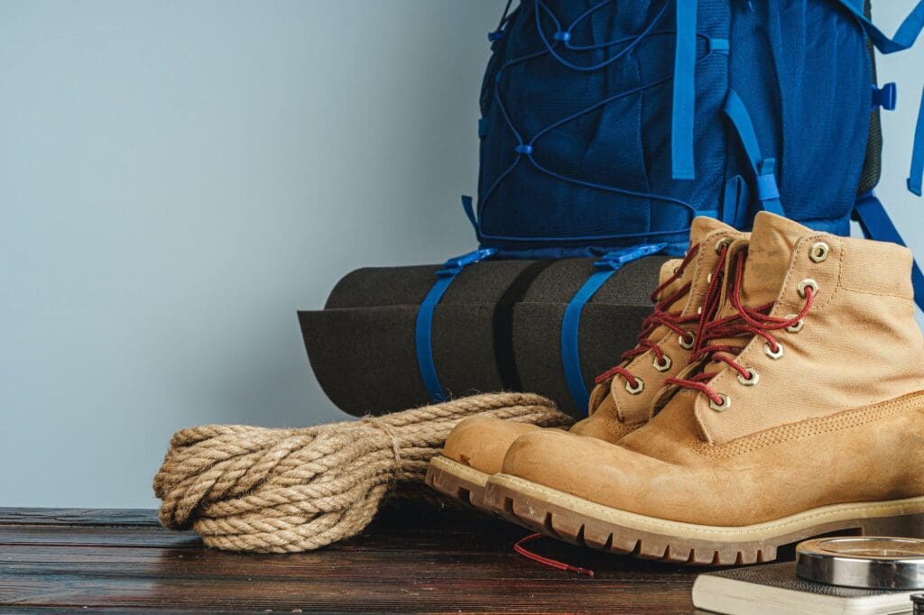 Hiking boots and rope hank on wooden board