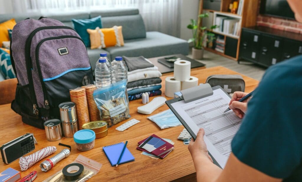 Woman doing inventory of prepper gear for bug out bag