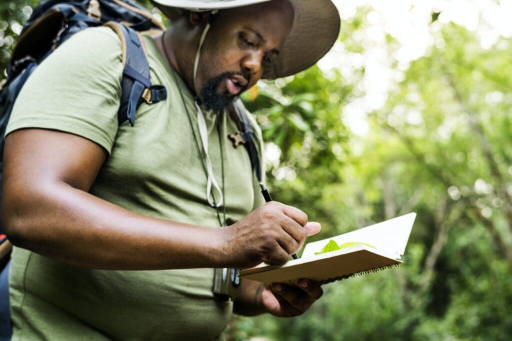 Botanist making notes in his notepad