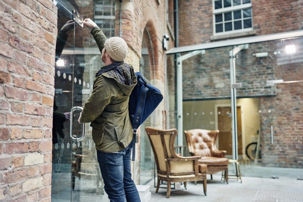 Male coffee shop owner unlocking door