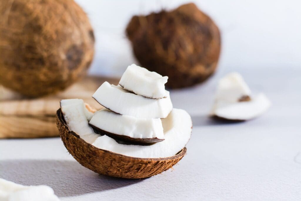 Pieces of ripe coconut on the table. Tropical fruits. Natural source of antioxidants. Close-up