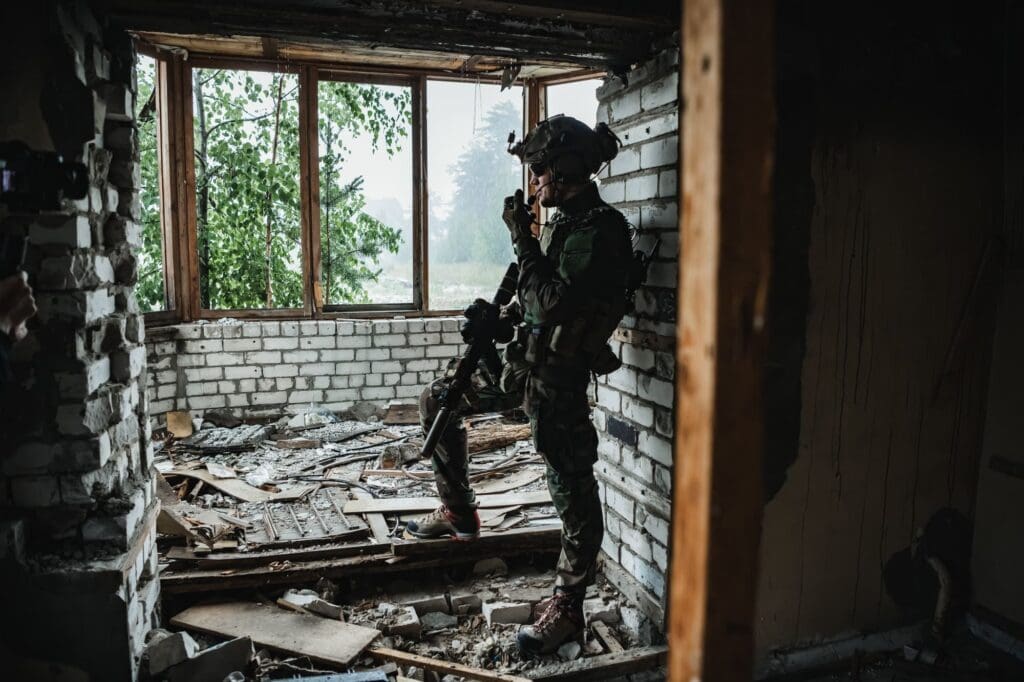 Soldier talking on the walkie-talkie inside the building, military concept