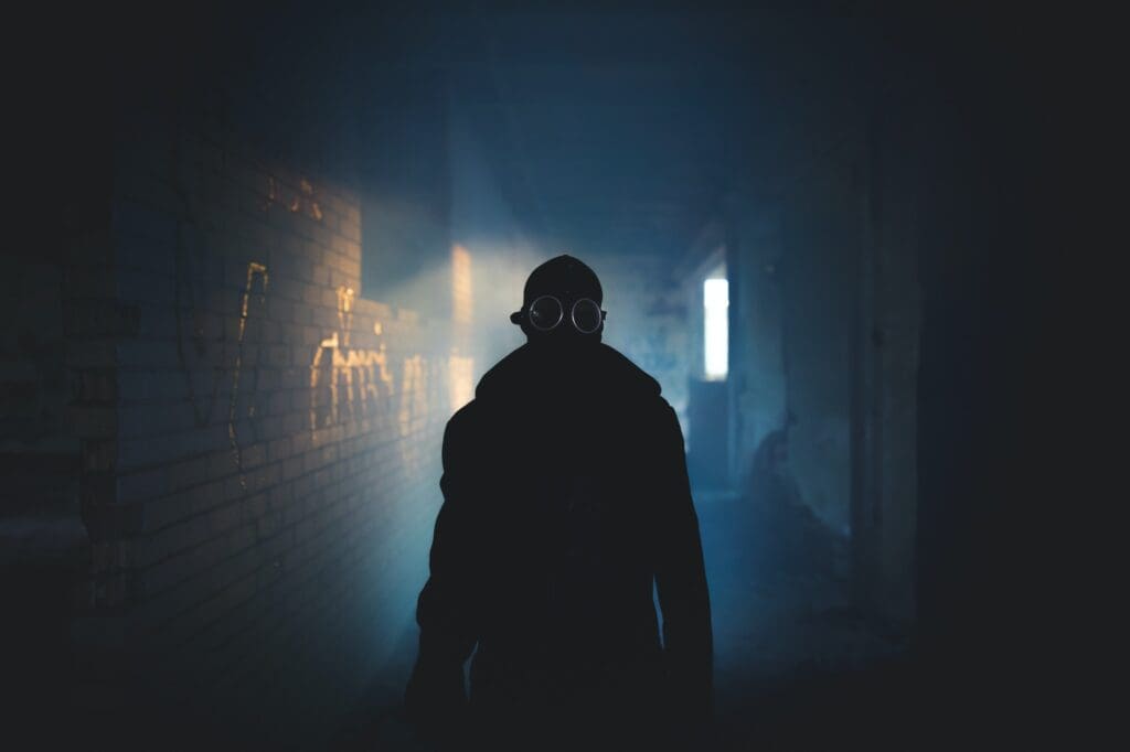 Man wearing protective gas mask for covid,covid19 and nuclear prevention. Film look and dark tones.