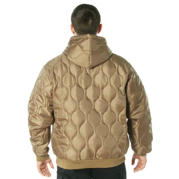 A person wearing a brown, puffy 2XL jacket is viewed from the back against a white background.