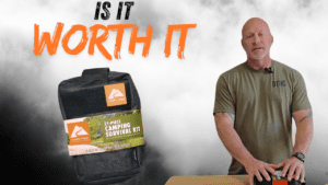 Person standing beside a table with a 21-piece Ozark Trail camping survival kit from Walmart. Text reads, "Is It Worth It?.