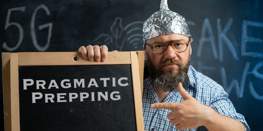 A man in a tinfoil hat gestures at a chalkboard adorned with "Pragmatic Prepping," while "5G" and "Fake News" linger in the background. It's a curious scene akin to a prepper's guide, blending cautionary tales with practical advice.